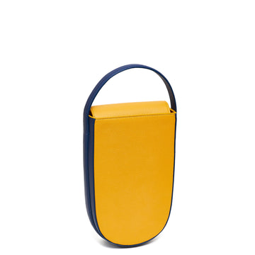 A colorful blue and yellow mini leather tote handbag. The handbag has an elongated rounded shape and a blue adjustable top handle. The hardware is gunmetal. This is the front view of the Tomoli Fitini bag in Shady Maize.