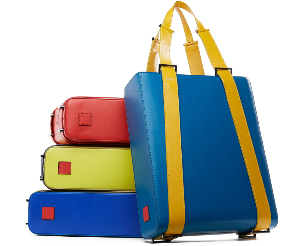 Colorful tote handbags with a structured rectangular shape and flat straps.