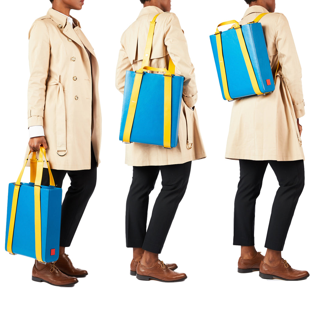 A style inspiration photo showing a model wearing the same blue tote three different ways. From left to right, the model holds the bag as a tote, then carries it over her shoulder, and last she wears it as a backpack. The bag is turquoise blue and is color-blocked with yellow straps. The bag has a structured rectangular briefcase shape. This is the Tomoli Kora large convertible leather tote in Golden Sky.