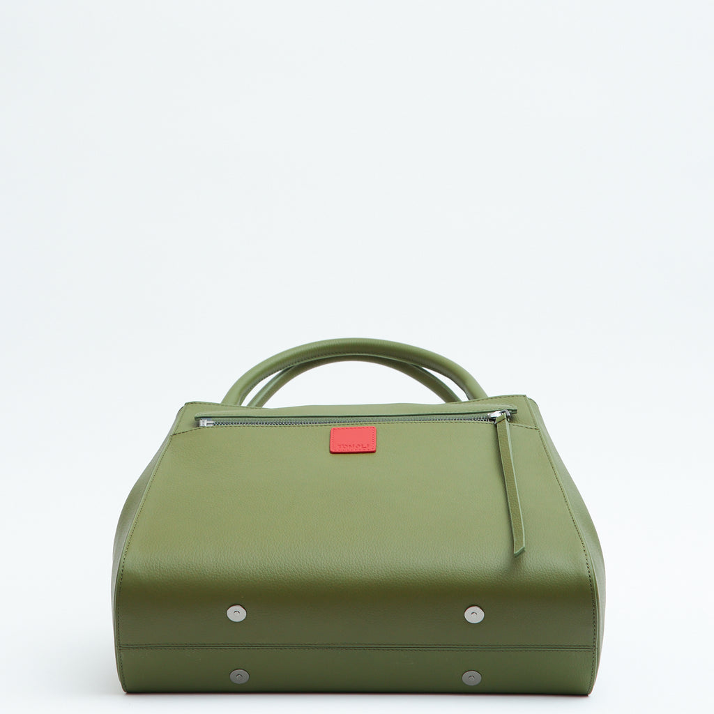 The product photo of an olive green leather handbag. The handbag has a classic trapeze shape with a back pocket, a zipper to interchange flaps, and top handles. This is the bottom view of the Tomoli Briffani Lean interchangeable tote handbag in Olive Green. This bag can be used as an everyday bag, a work tote, or even an oversized clutch.