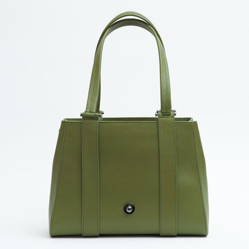 The product photo of an olive green tote leather handbag. The handbag has a classic trapeze shape with a back pocket, a zipper to interchange flaps, and top handles. This is the back view of the Tomoli Briffani Orbit interchangeable tote handbag in Olive Green. This bag can be used as an everyday bag, a work tote, or even an oversized clutch.