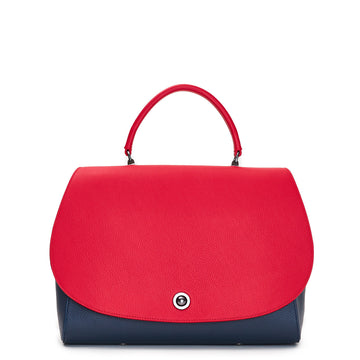 The product photo of a colorful blue and red top handle leather handbag. The handbag has a red oversized round flap cover on a dark blue body. This is the Tomoli Briffani Jut in Hot Denim.