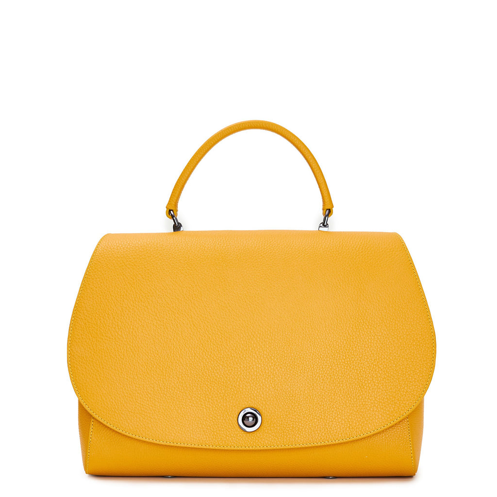 The product photo of a colorful yellow top handle leather handbag. The handbag has a minimalistic design and an oversized round flap cover. This is the Tomoli Briffani Jut in Maize.